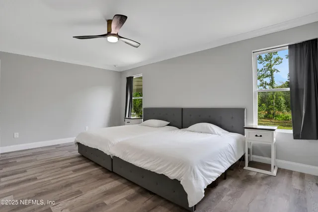 a bedroom with a large bed and a chandelier