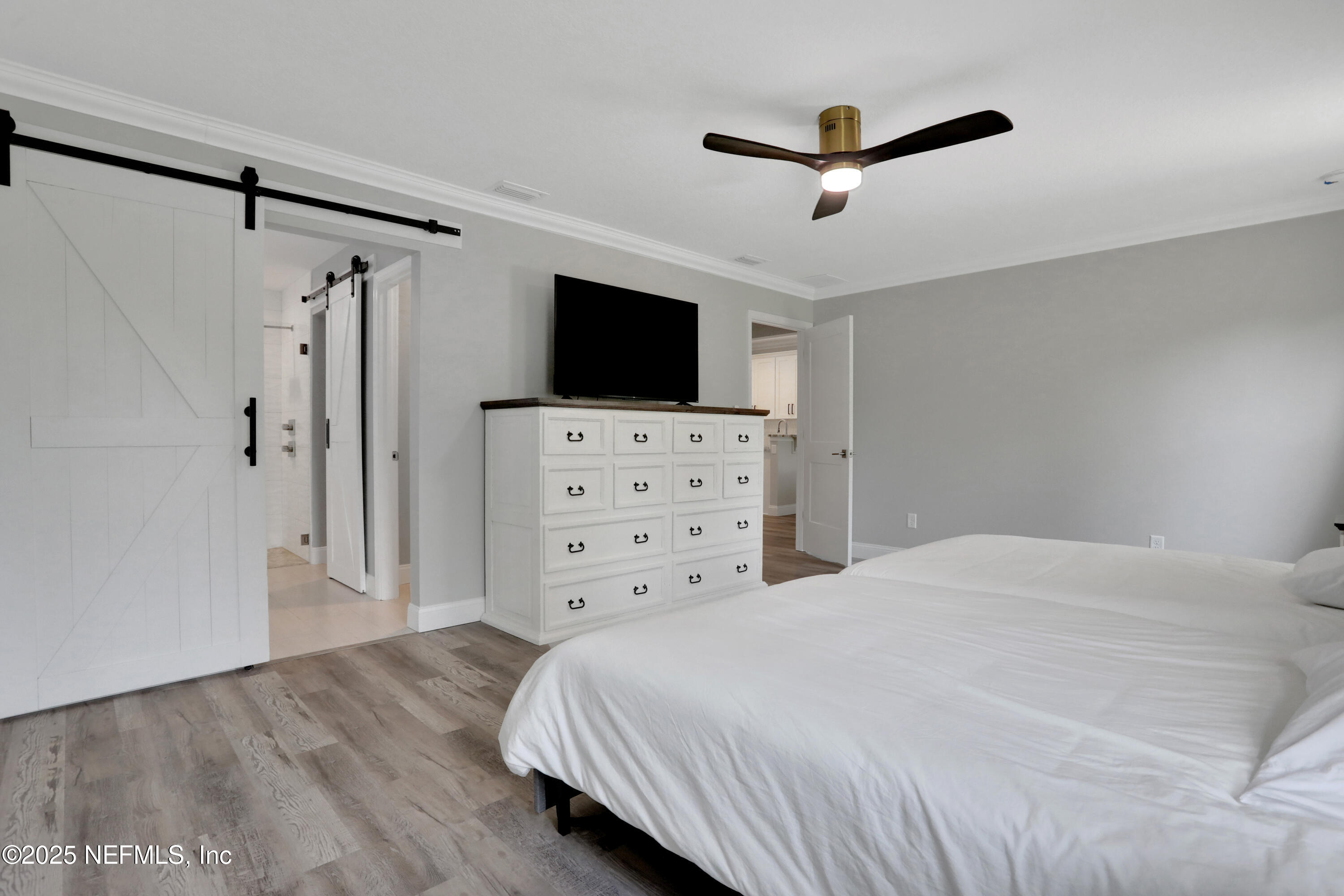 4467 Monroe Smith Road Jacksonville, FL 32210 - Photo 29 of 61 a bedroom with a bed and a flat screen tv