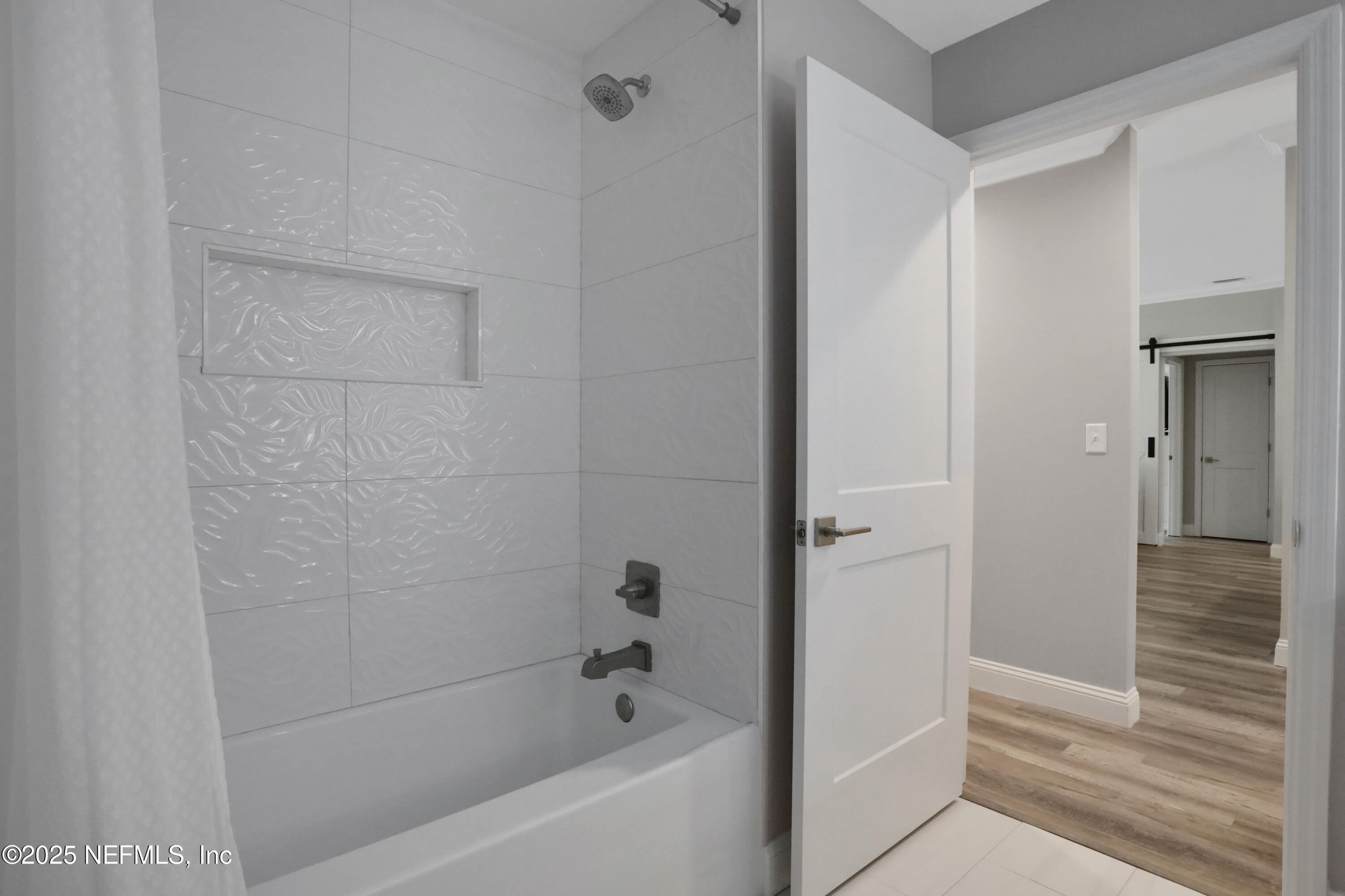 4467 Monroe Smith Road Jacksonville, FL 32210 - Photo 33 of 61 a bathroom with a bathtub