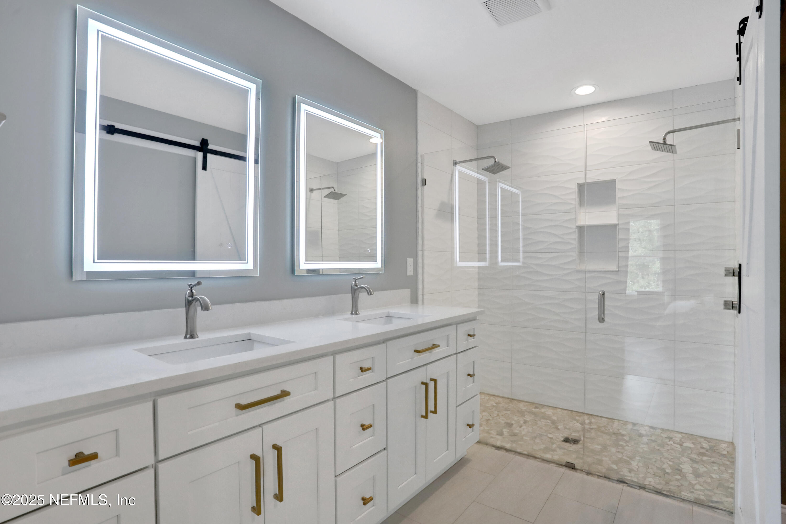 4467 Monroe Smith Road Jacksonville, FL 32210 - Photo 38 of 61 a bathroom with double sink and a mirror