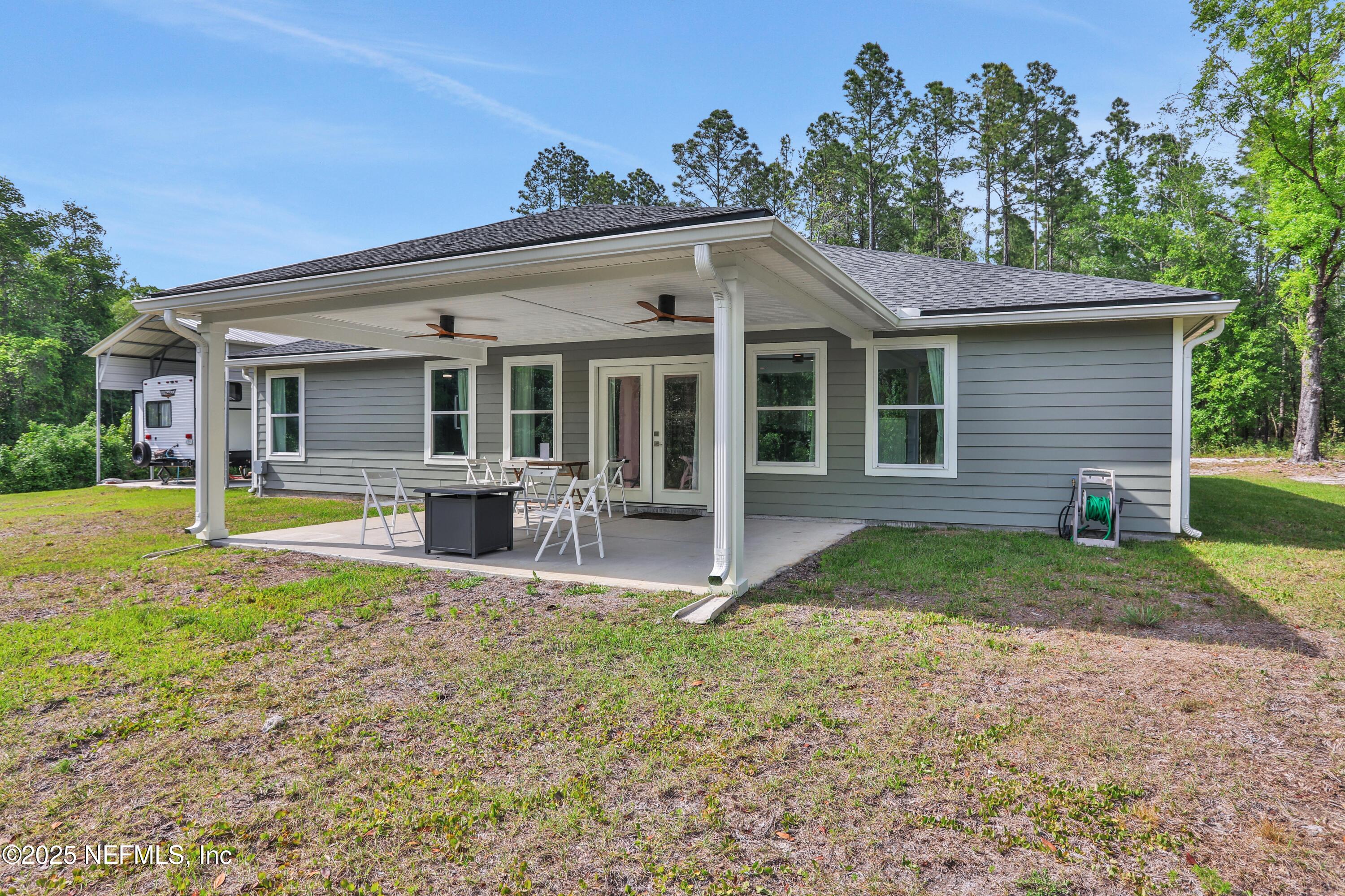 4467 Monroe Smith Road Jacksonville, FL 32210 - Photo 50 of 61 a view of a house with backyard porch and sitting area