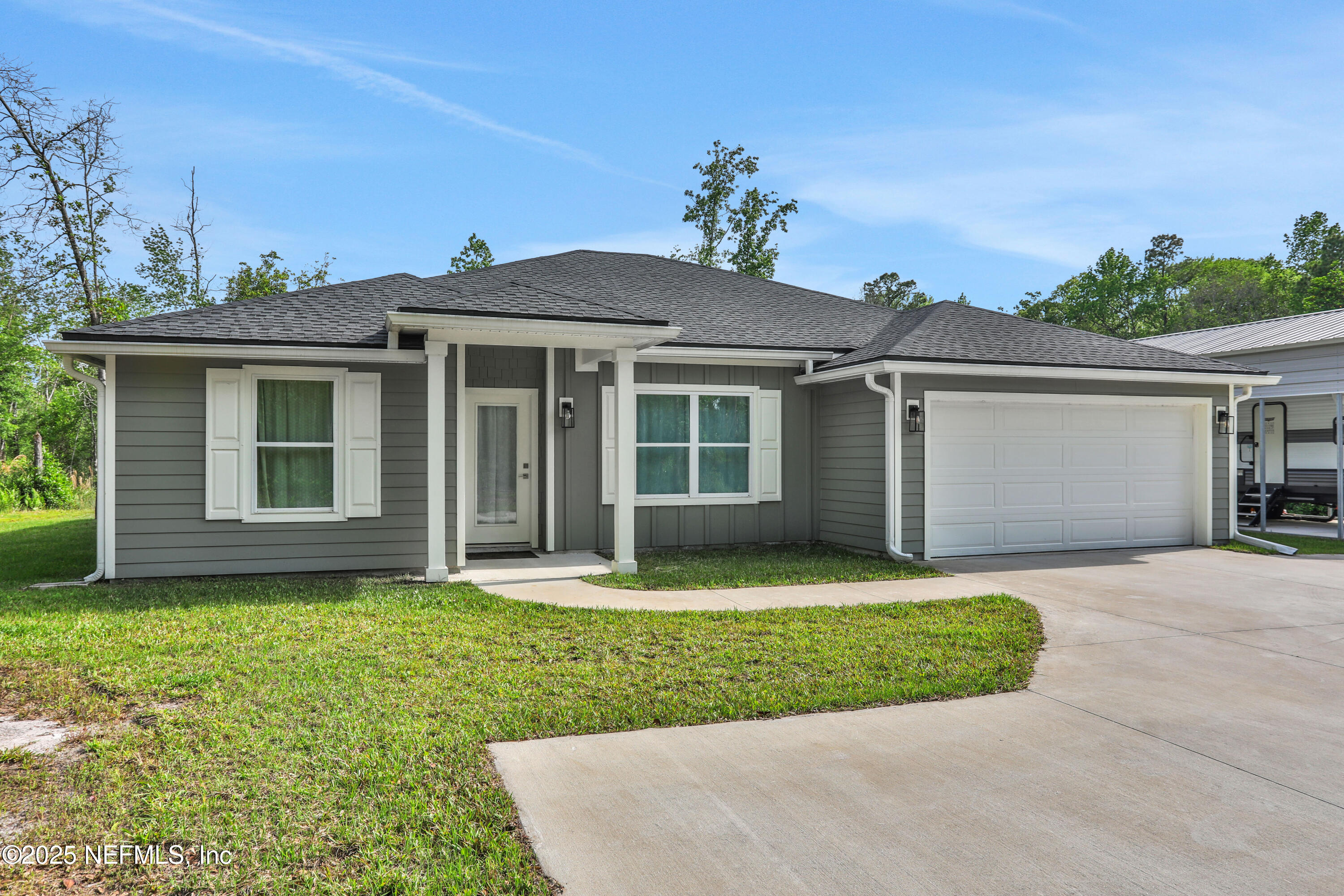 4467 Monroe Smith Road Jacksonville, FL 32210 - Photo 5 of 61 front view of a house and a yard
