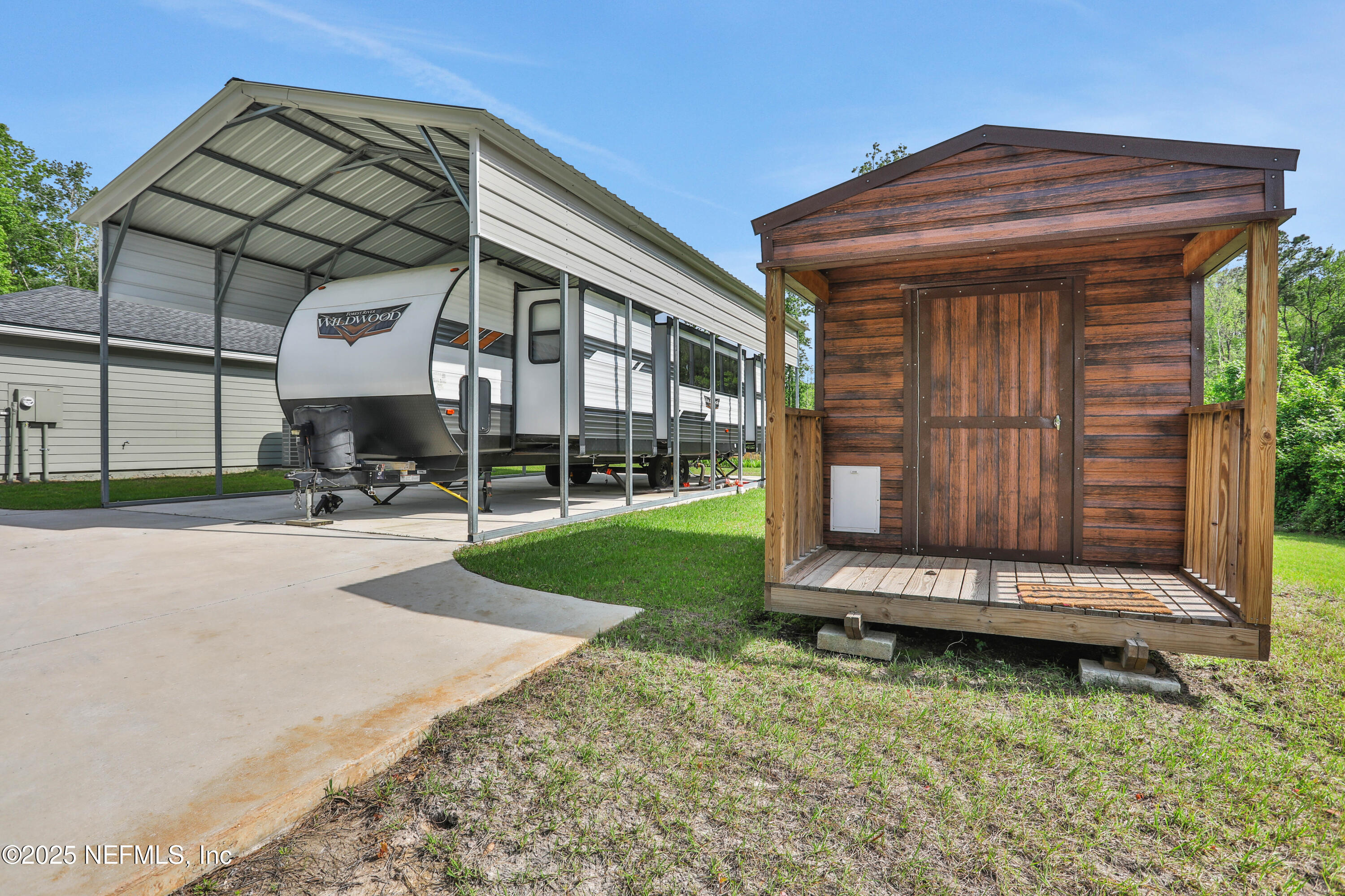 4467 Monroe Smith Road Jacksonville, FL 32210 - Photo 55 of 61 a view of a chair and table in backyard of the house