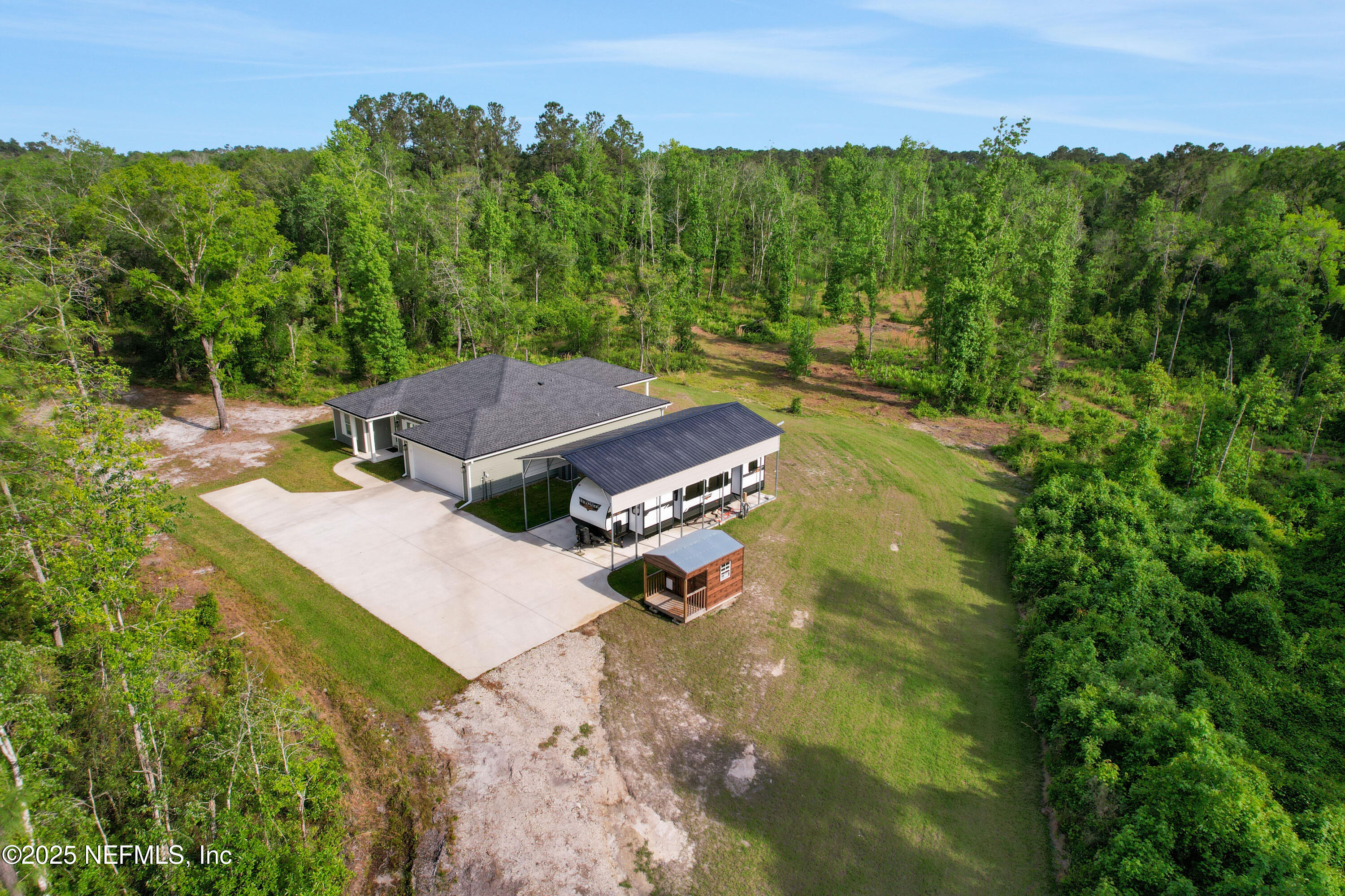 4467 Monroe Smith Road Jacksonville, FL 32210 - Photo 9 of 61 an aerial view of a house with yard and green space