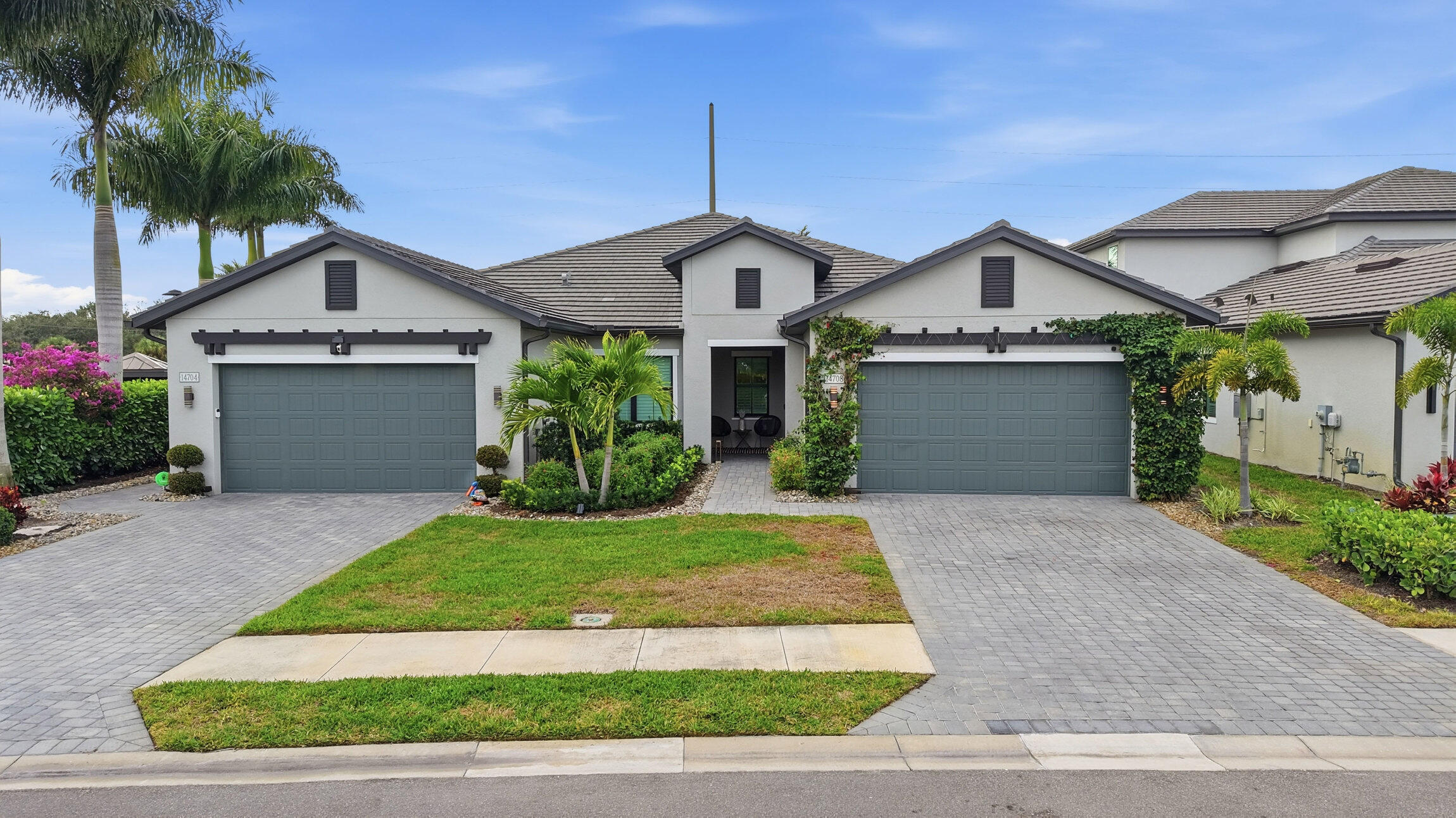 14708 Kingfisher Loop Naples, FL 34120 - Photo 38 of 42 a front view of a house with a yard and garage