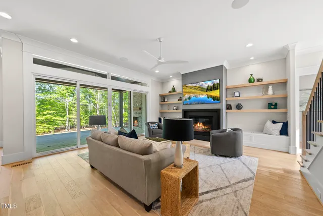 a living room with furniture a flat screen tv and a fireplace