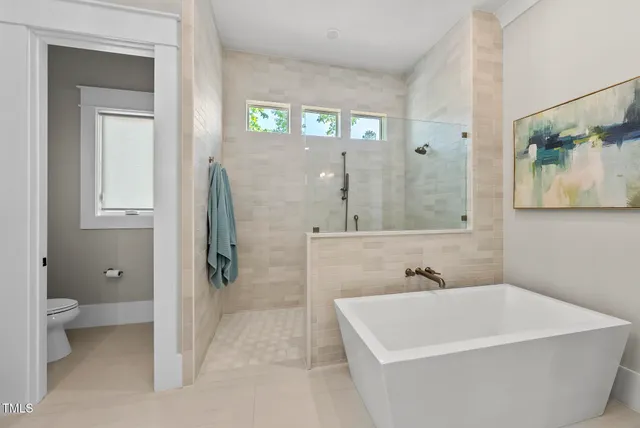 a bedroom with a large bed and a couch