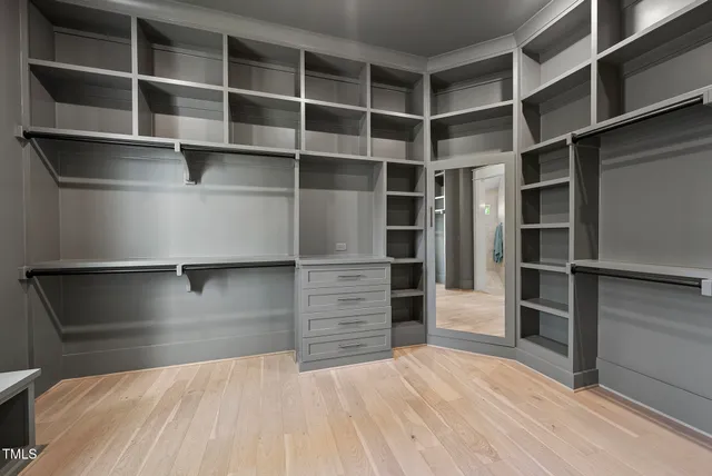 a bedroom with a large bed couch and a window