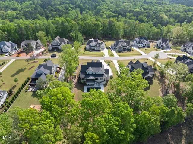 an aerial view of a house with a yard and garden