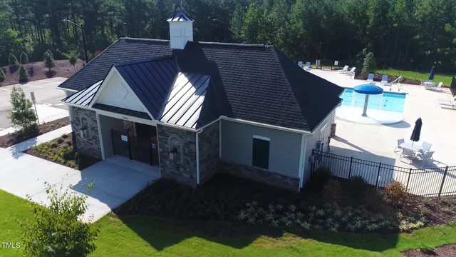 an aerial view of a house with a yard basket ball court and outdoor seating