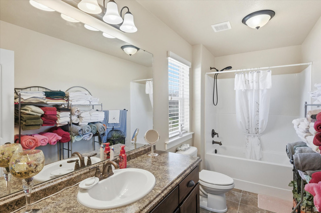 1084 South 740 East Logan, UT 84321 - Photo 9 of 23 Bathroom with vanity and shower / tub combo with curtain