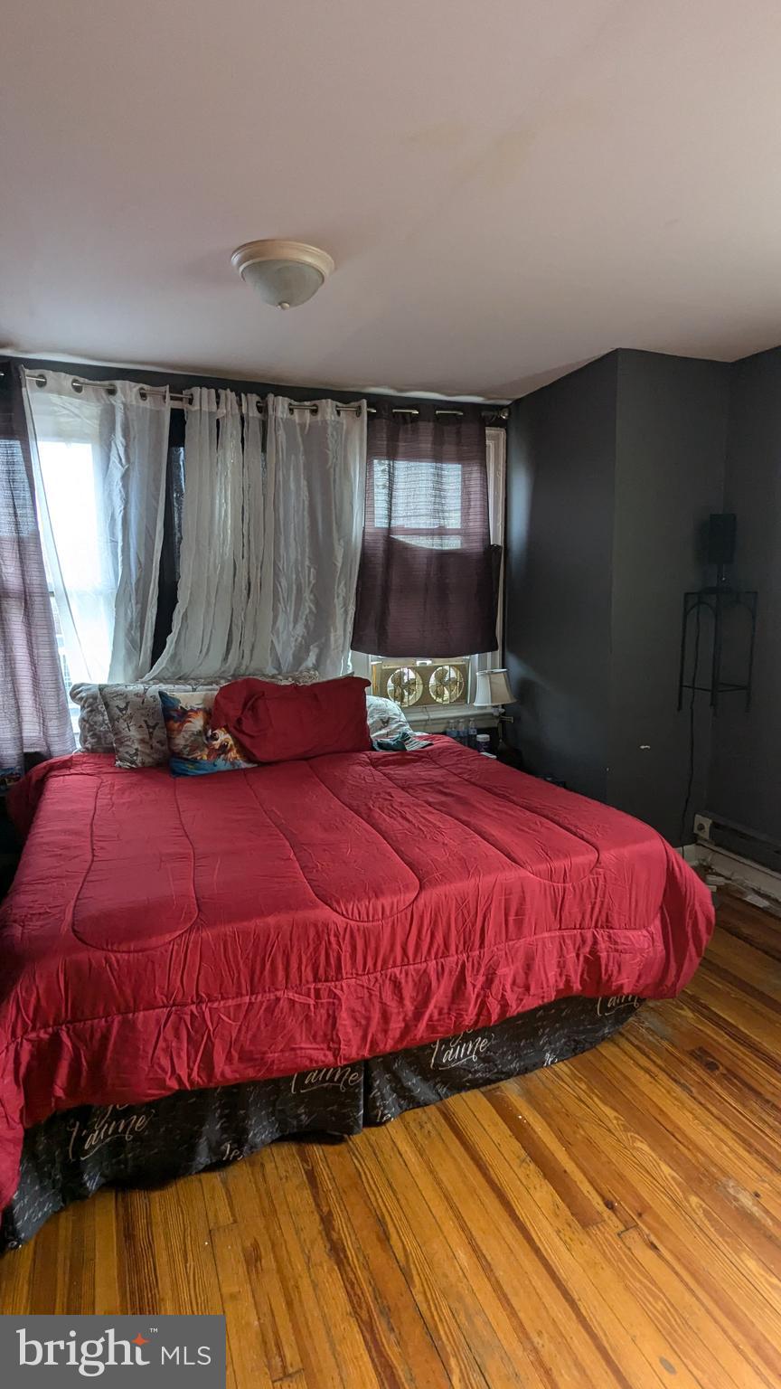 1850 South 54th Street Philadelphia, PA 19143 - Photo 11 of 13 a bed sitting in a bedroom next to a window