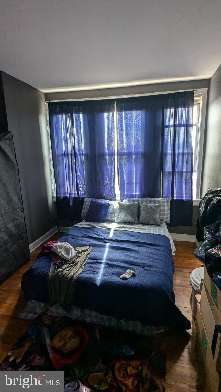 1850 South 54th Street Philadelphia, PA 19143 - Photo 10 of 13 a bed sitting in a room next to a window
