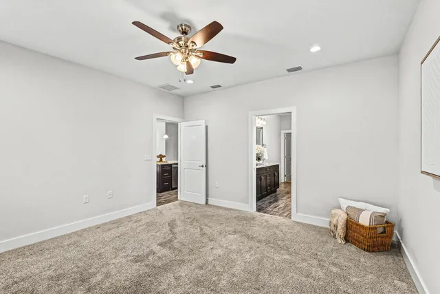 an empty room with closet and windows