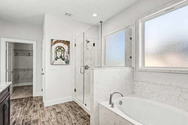 a bathroom with a bathtub and a shower