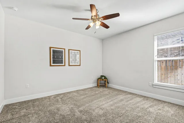 a view of room with a ceiling fan