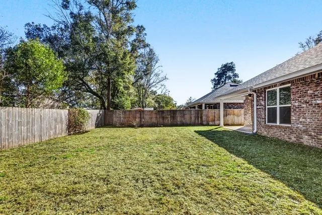 a backyard of a house with lots of green space