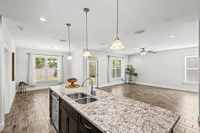 a kitchen with sink stove and refrigerator