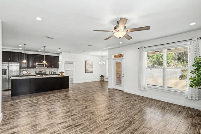 a view of kitchen with sink and wooden floor