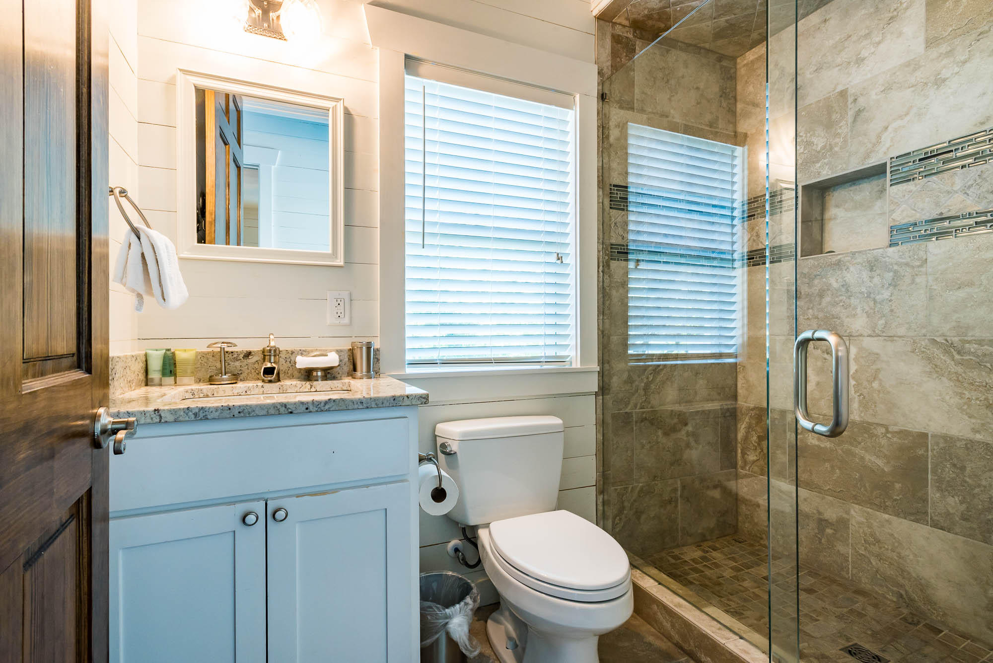 110 Gulf Point Road Santa Rosa Beach, FL 32459 - Photo 19 of 39 a bathroom with a granite countertop toilet a sink a mirror and shower