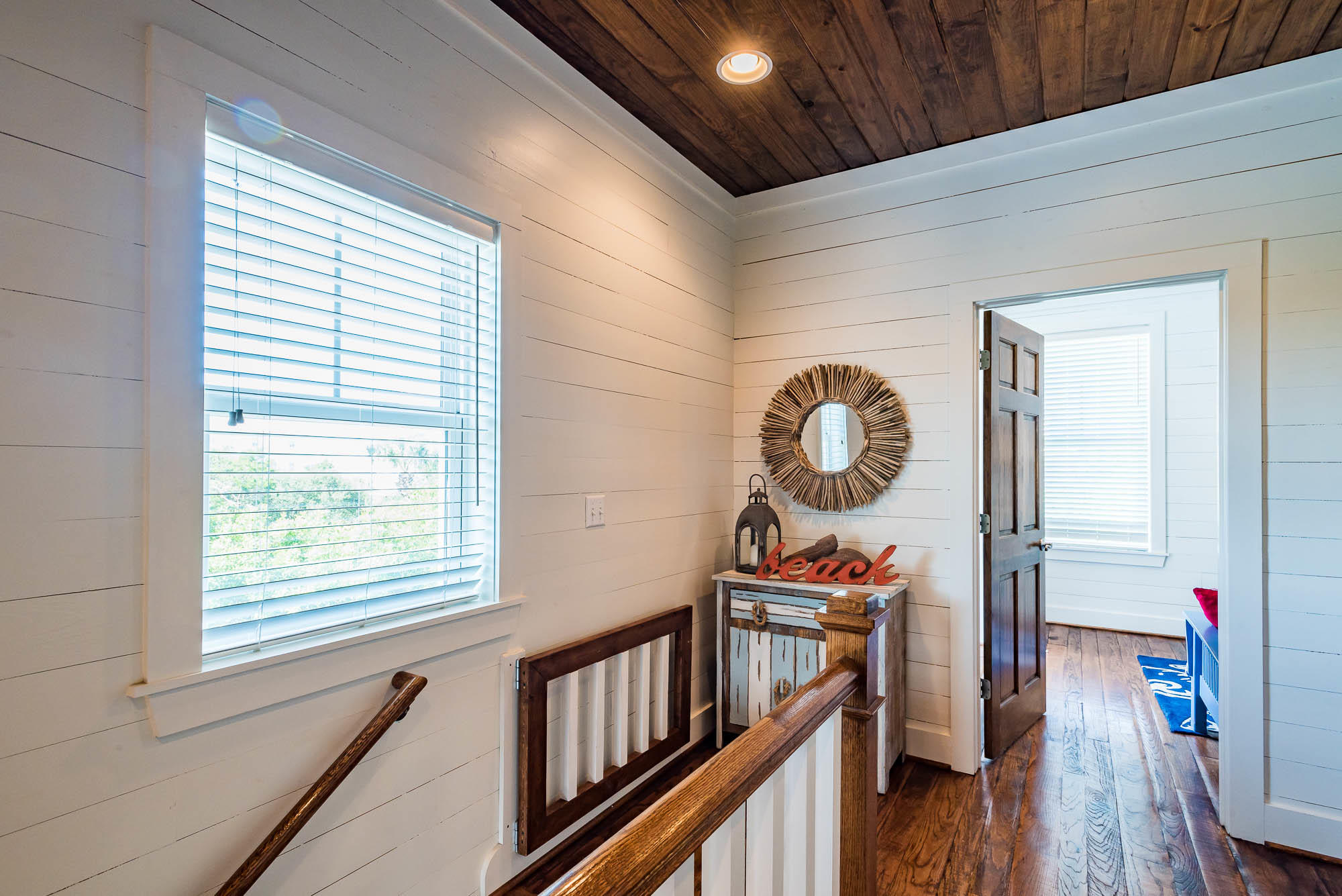 110 Gulf Point Road Santa Rosa Beach, FL 32459 - Photo 20 of 39 a view of a hallway with wooden floor and staircase