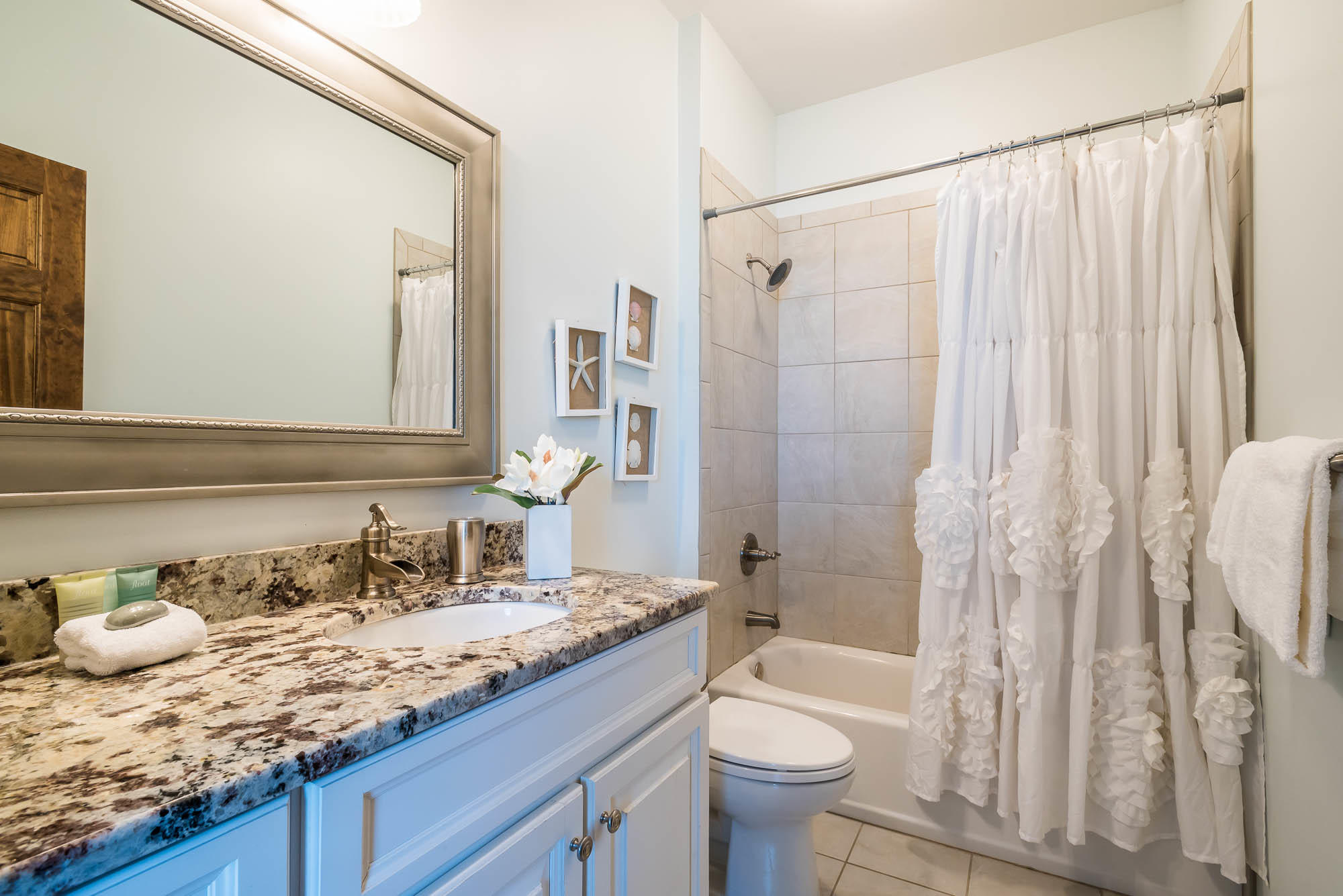 110 Gulf Point Road Santa Rosa Beach, FL 32459 - Photo 27 of 39 a bathroom with a granite countertop sink and a mirror