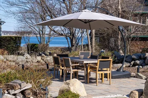 a view of a tables and chairs under an umbrella