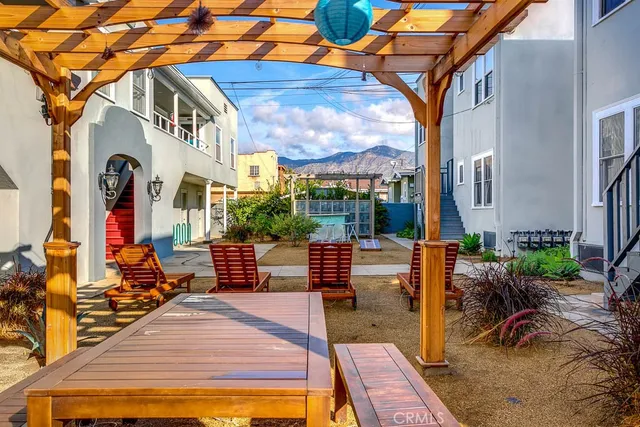a view of a patio with couches table and chairs and potted plants
