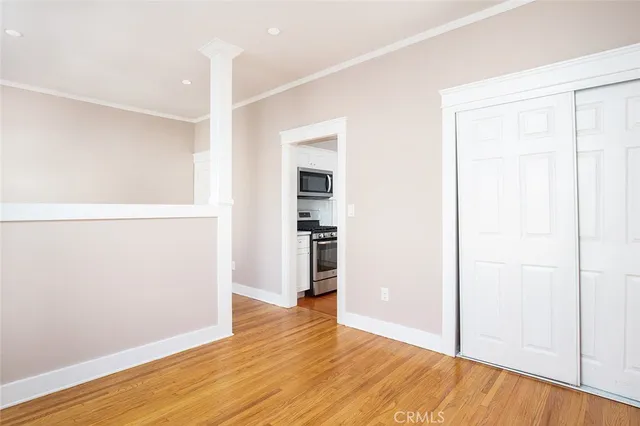 a view of empty room with wooden floor