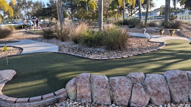 a view of a tennis ground with large trees