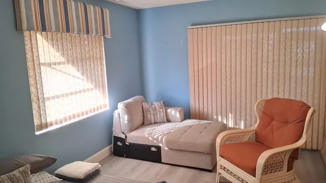 a dining room with furniture a chandelier and wooden floor