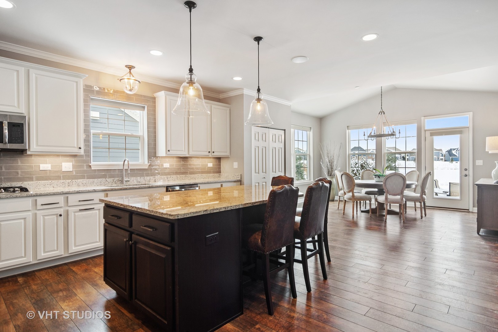 3577 Harold Circle Hoffman Estates, IL 60192 - Photo 6 of 32 a kitchen with center island dining table and stainless steel appliances