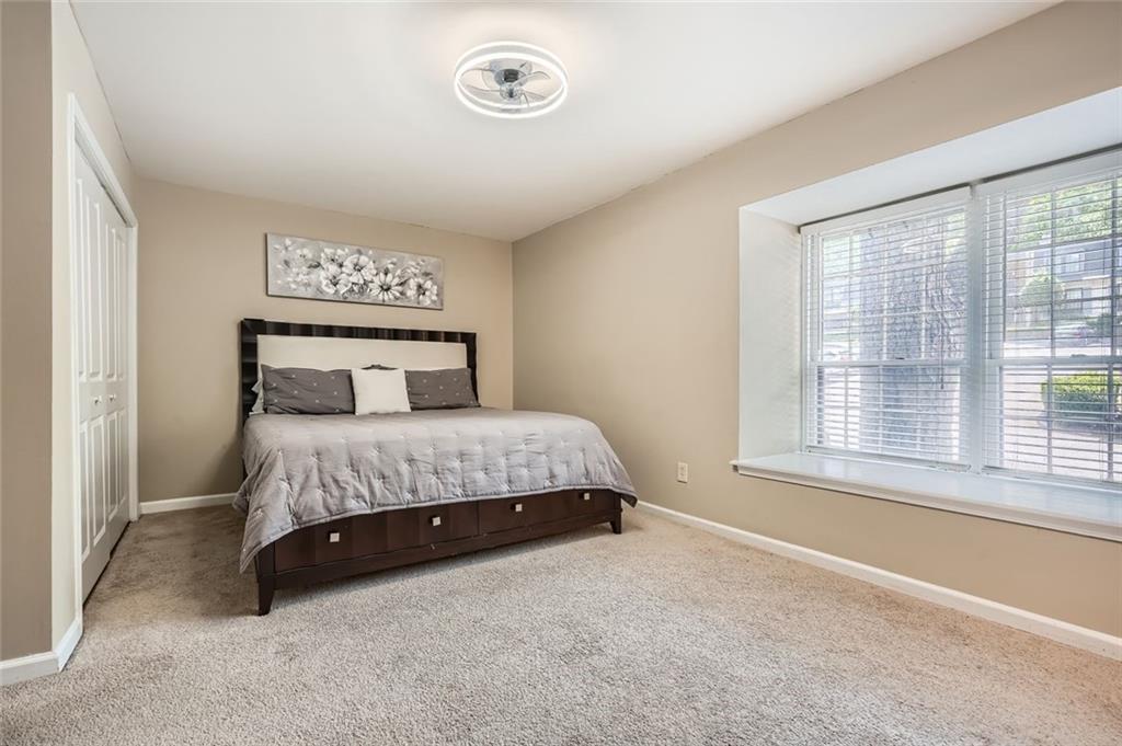 81 La Rue Place Northwest Atlanta, GA 30327 - Photo 14 of 24 a bedroom with a bed and a window
