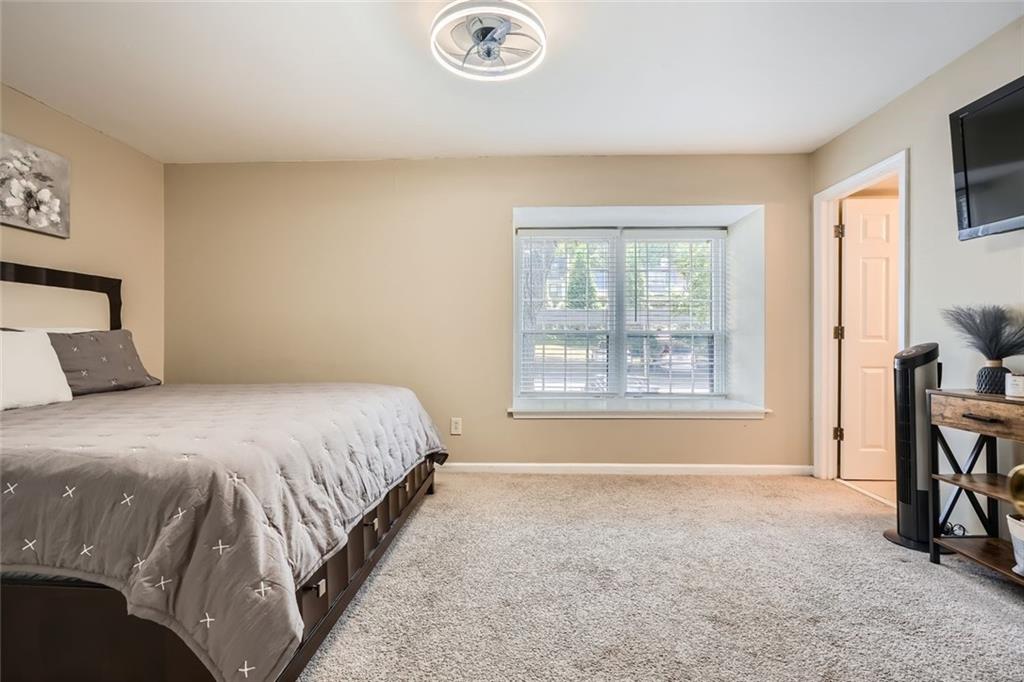 81 La Rue Place Northwest Atlanta, GA 30327 - Photo 15 of 24 a bedroom with a bed and a window