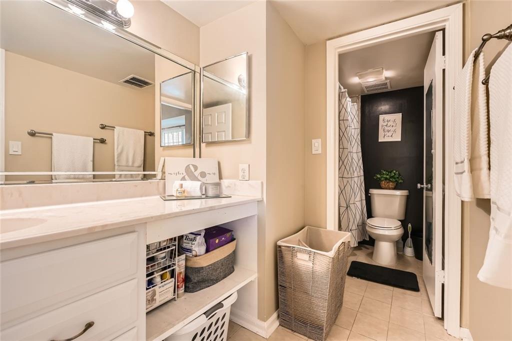 81 La Rue Place Northwest Atlanta, GA 30327 - Photo 17 of 24 a bathroom with a toilet a sink and mirror