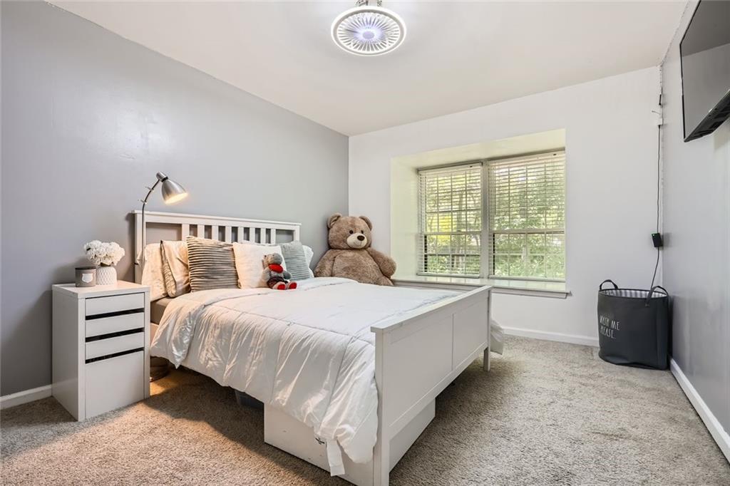 81 La Rue Place Northwest Atlanta, GA 30327 - Photo 18 of 24 a bedroom with a bed and a window