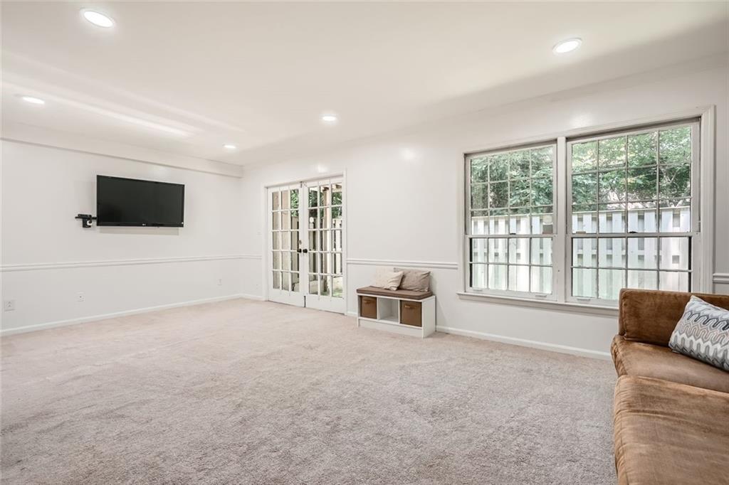 81 La Rue Place Northwest Atlanta, GA 30327 - Photo 21 of 24 a living room with furniture a flat screen tv and a large window