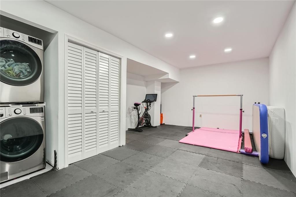 81 La Rue Place Northwest Atlanta, GA 30327 - Photo 22 of 24 a view of a hallway with washer and dryer
