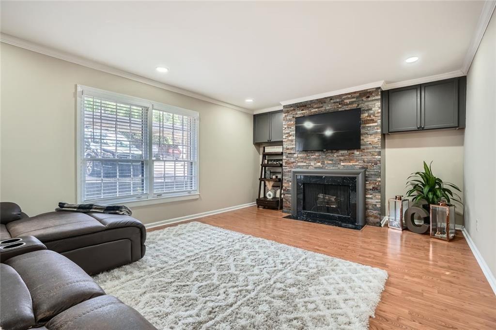 81 La Rue Place Northwest Atlanta, GA 30327 - Photo 4 of 24 a living room with furniture a fireplace and a flat screen tv