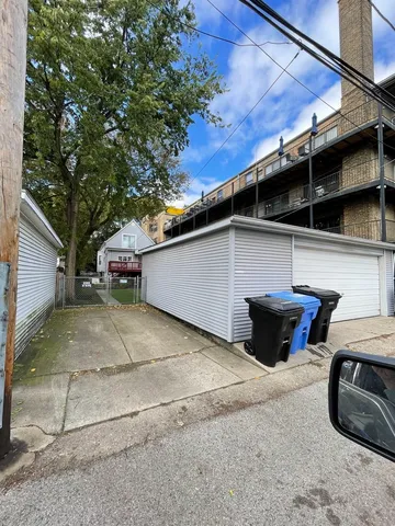 a backyard of a house with barbeque oven table and chairs