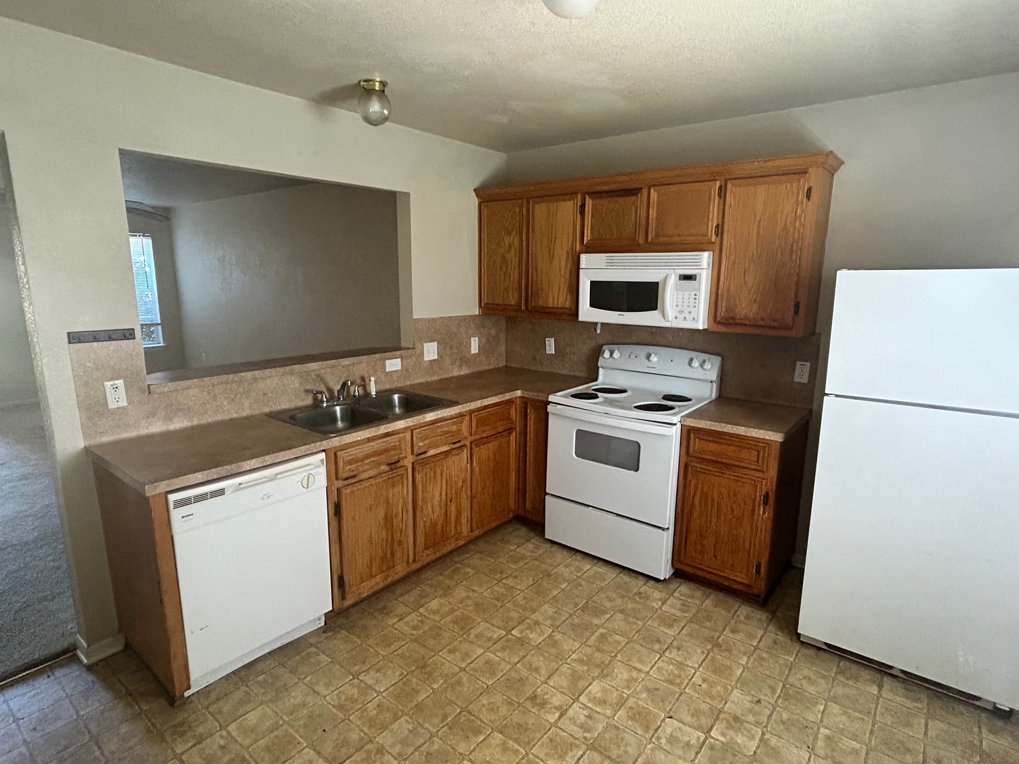 3104 Yaupon Road Copperas Cove, TX 76522 - Photo 2 of 9 Kitchen featuring white appliances, wood finish cabinets, and light countertops
