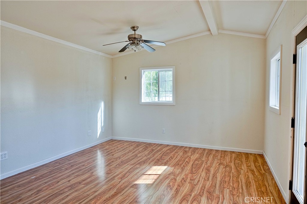 33342 Trail Ranch Road Agua Dulce, CA 91390 - Photo 21 of 40 a view of empty room with wooden floor and fan