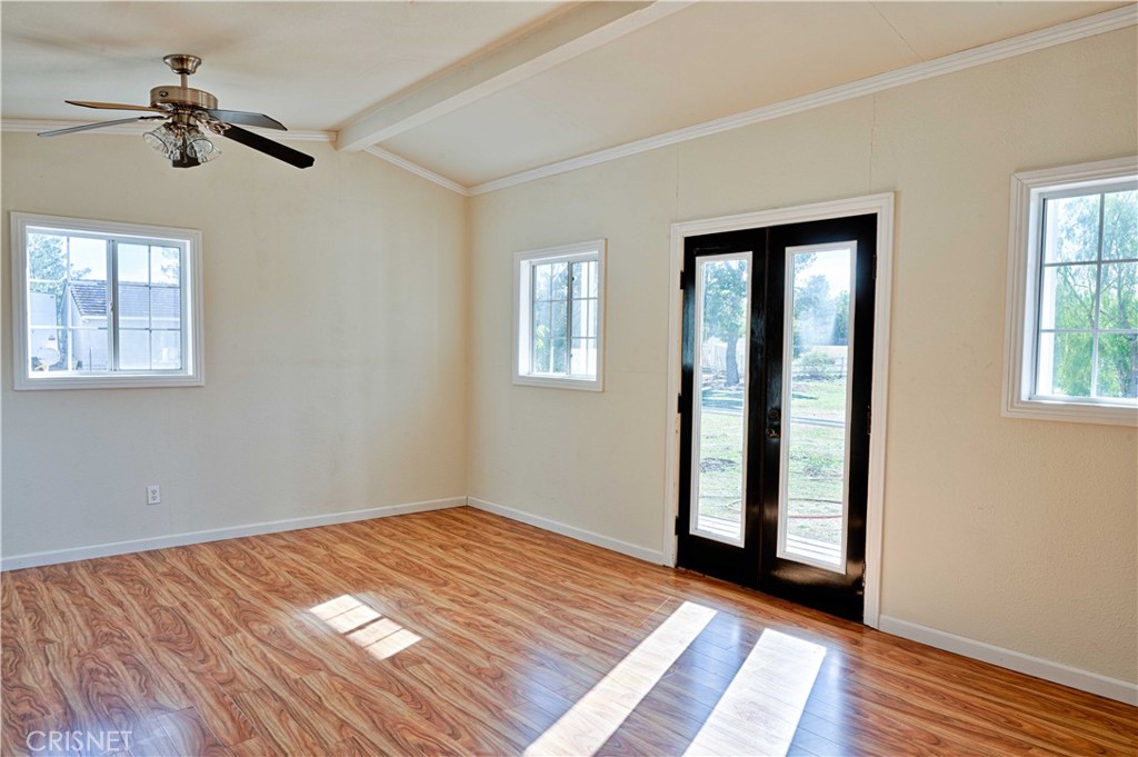 33342 Trail Ranch Road Agua Dulce, CA 91390 - Photo 22 of 40 a view of an empty room with wooden floor and a window