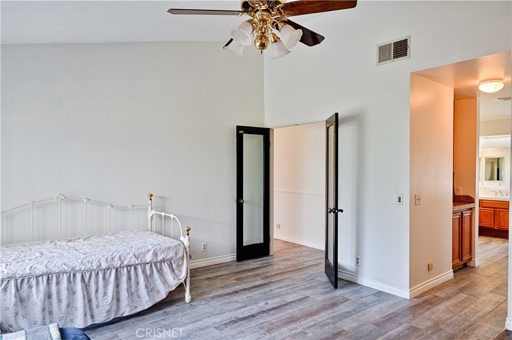 33342 Trail Ranch Road Agua Dulce, CA 91390 - Photo 24 of 40 a bedroom with a bed and wooden floor