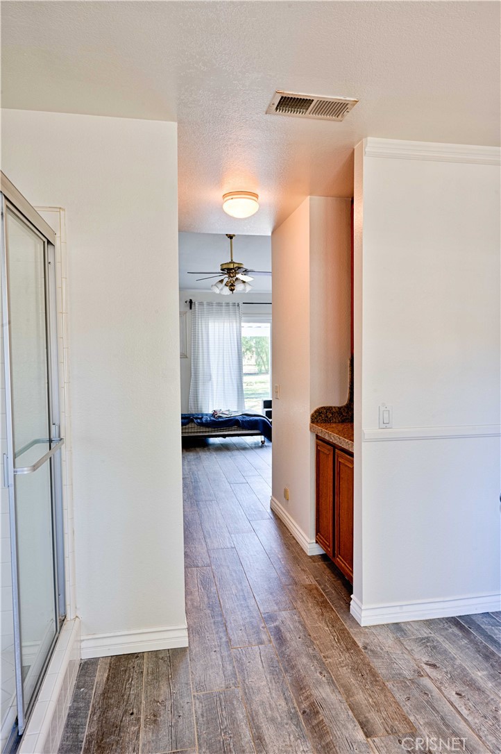 33342 Trail Ranch Road Agua Dulce, CA 91390 - Photo 29 of 40 a view of a kitchen with refrigerator and wooden floor