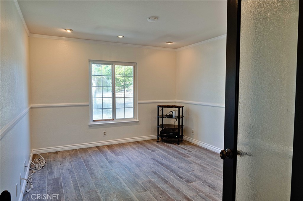 33342 Trail Ranch Road Agua Dulce, CA 91390 - Photo 32 of 40 an empty room with wooden floor and windows