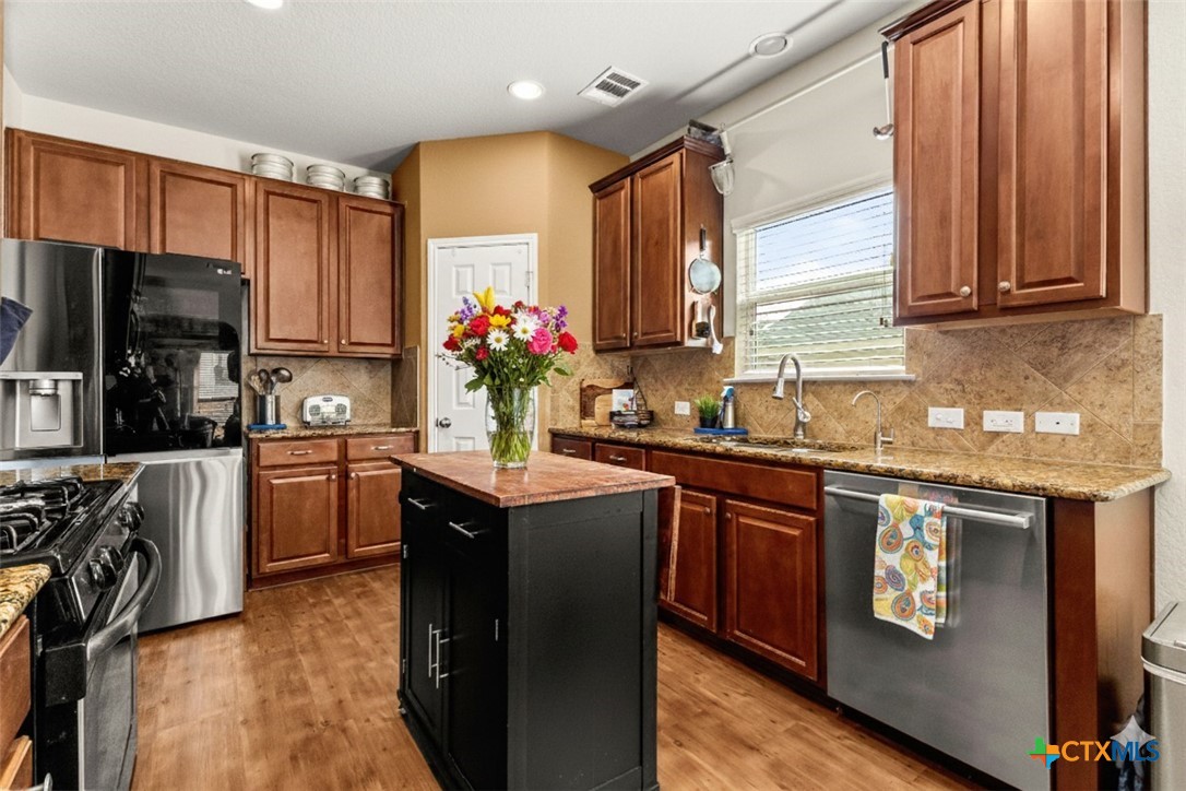2909 Oak Branch Ridge New Braunfels, TX 78130 - Photo 8 of 39 kitchen, some items virtually staged, home is vacant, island cart is on wheels