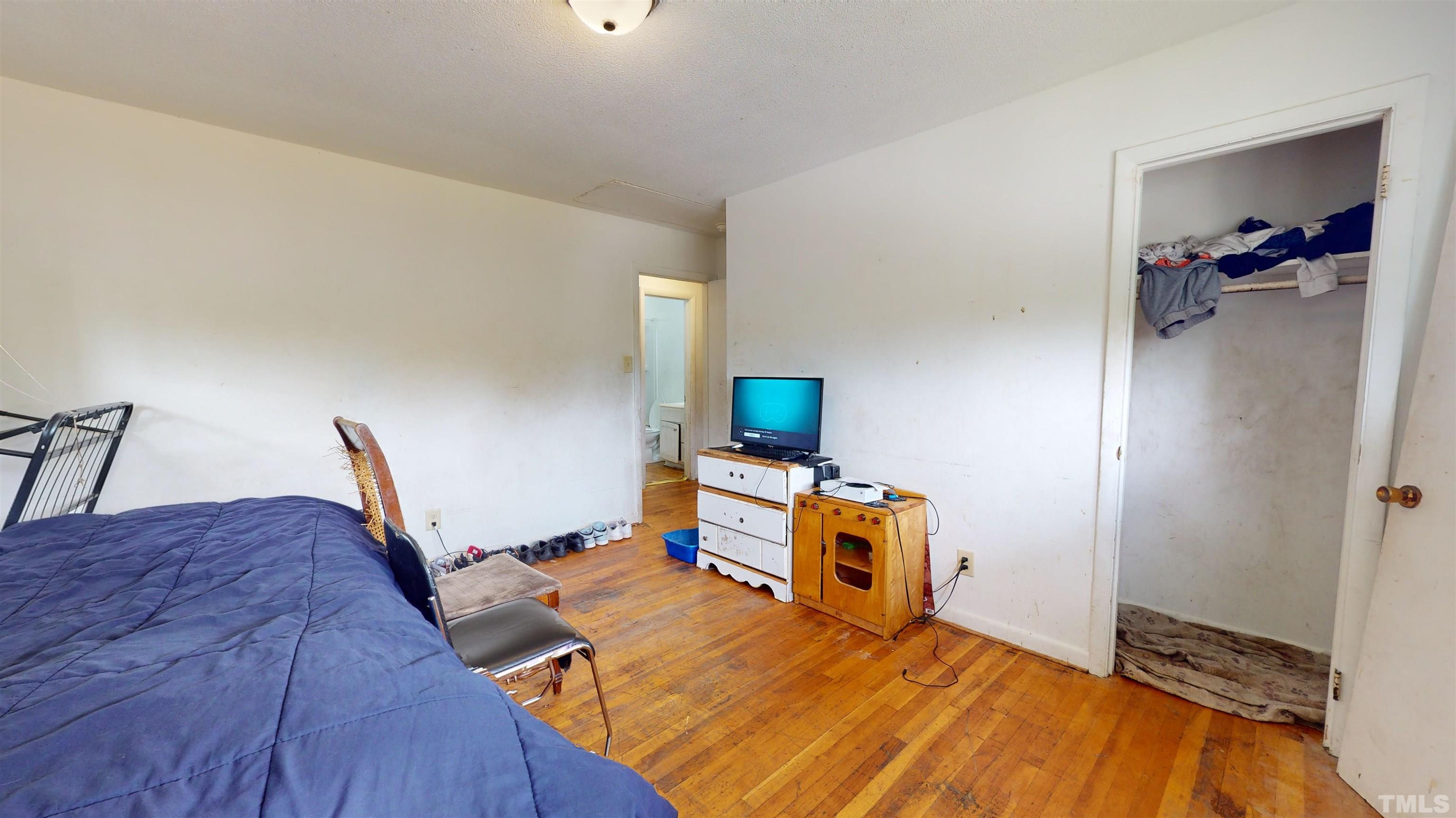 1101 Kitt Place Raleigh, NC 27610 - Photo 14 of 41 a bedroom with furniture and a wooden floor