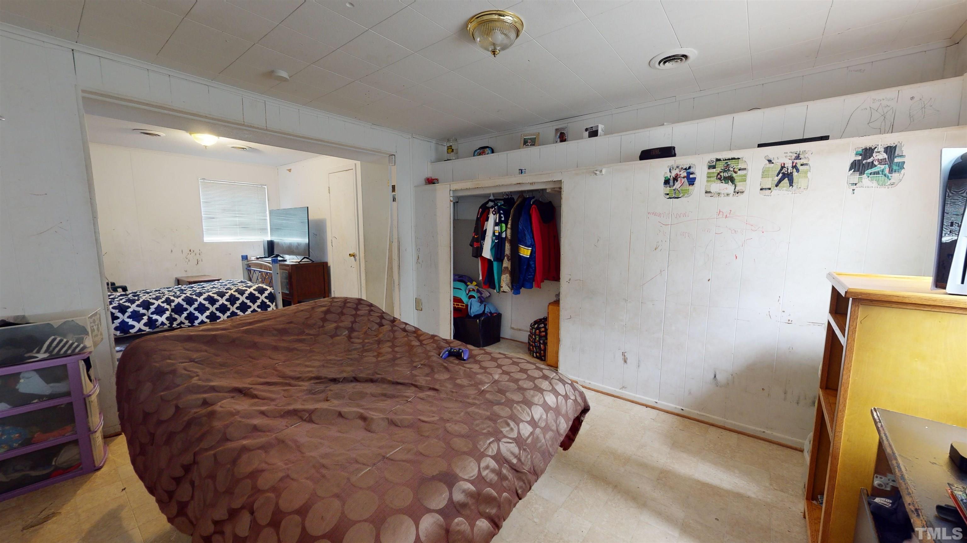 1101 Kitt Place Raleigh, NC 27610 - Photo 20 of 41 a bedroom with a bed and a refrigerator
