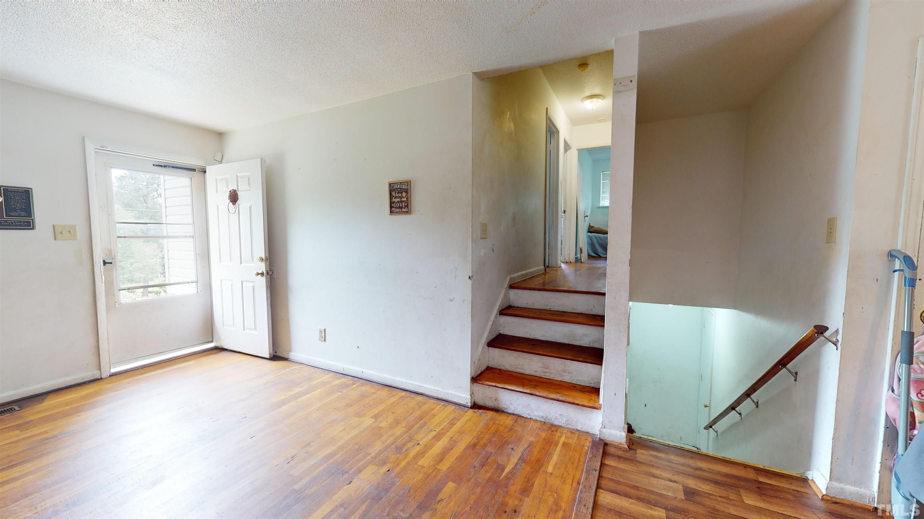 1101 Kitt Place Raleigh, NC 27610 - Photo 2 of 41 a view of a hallway with stairs and wooden floor